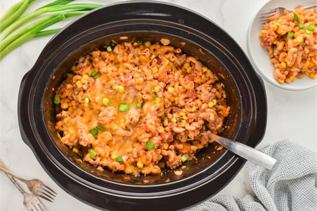 Crockpot filled with ground beef casserole.