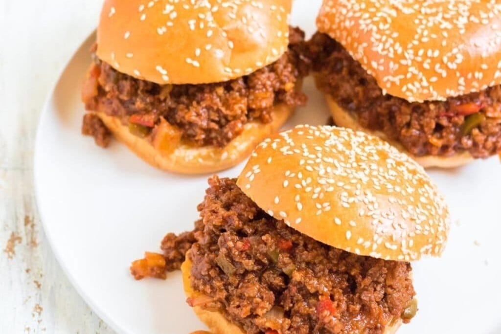 Three crockpot sloppy joes on a white plate.