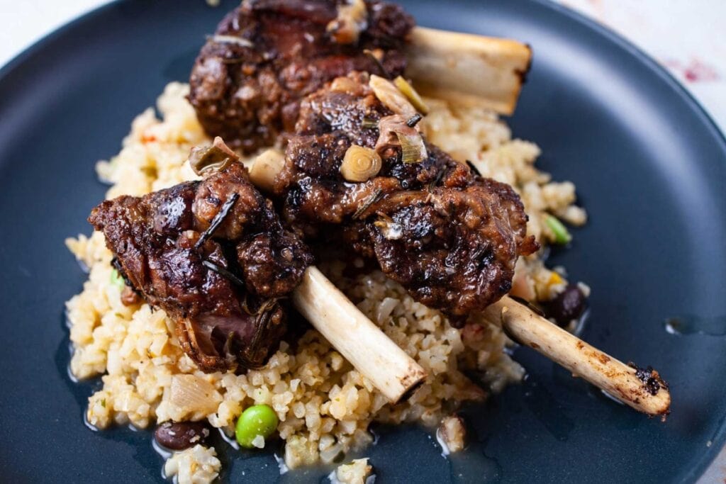 Crockpot spicy beef short ribs served over rice.