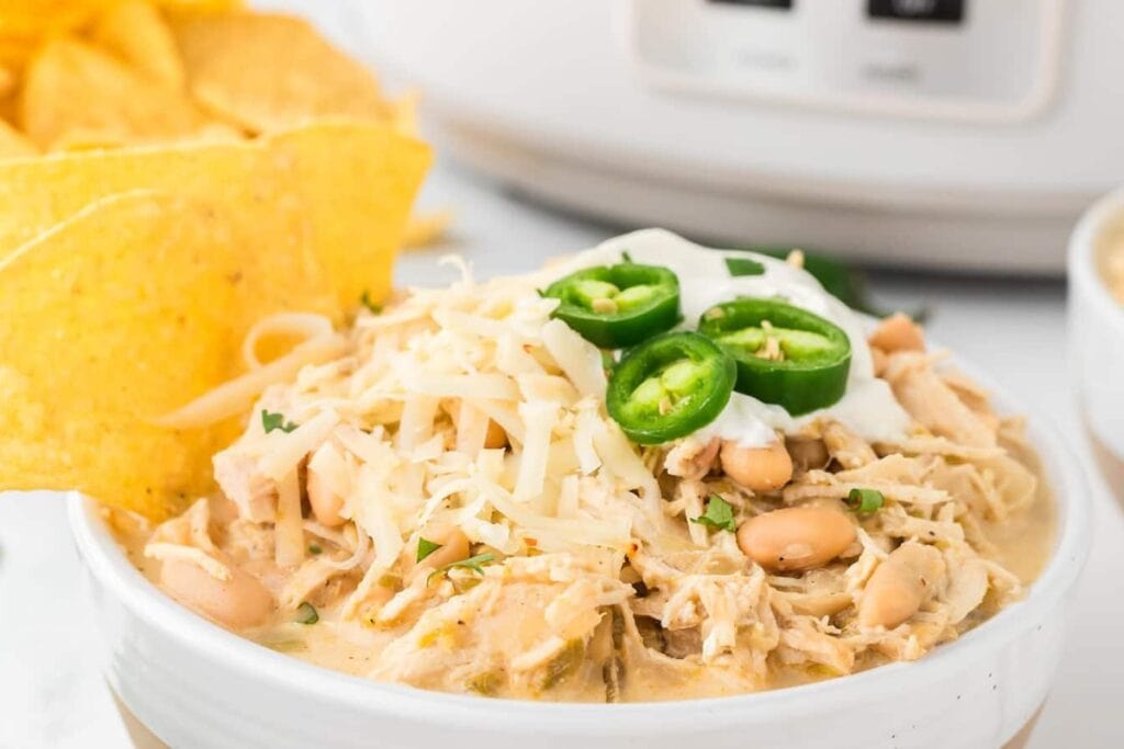 Crockpot white chicken chili in a white bowl.