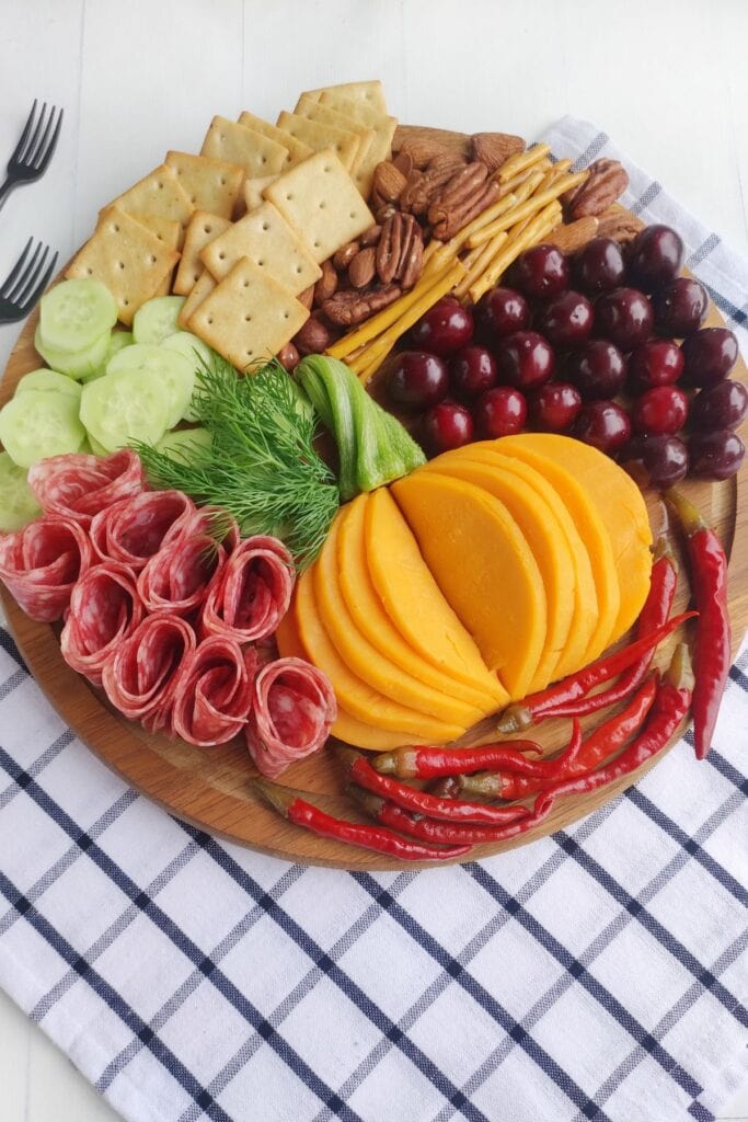 Fall charcuterie board on a checkered cloth.