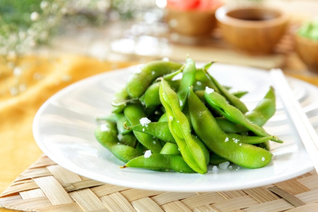 Edamame on a white plate.