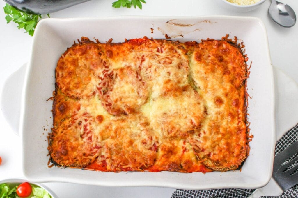 Eggplant casserole in a white baking dish.