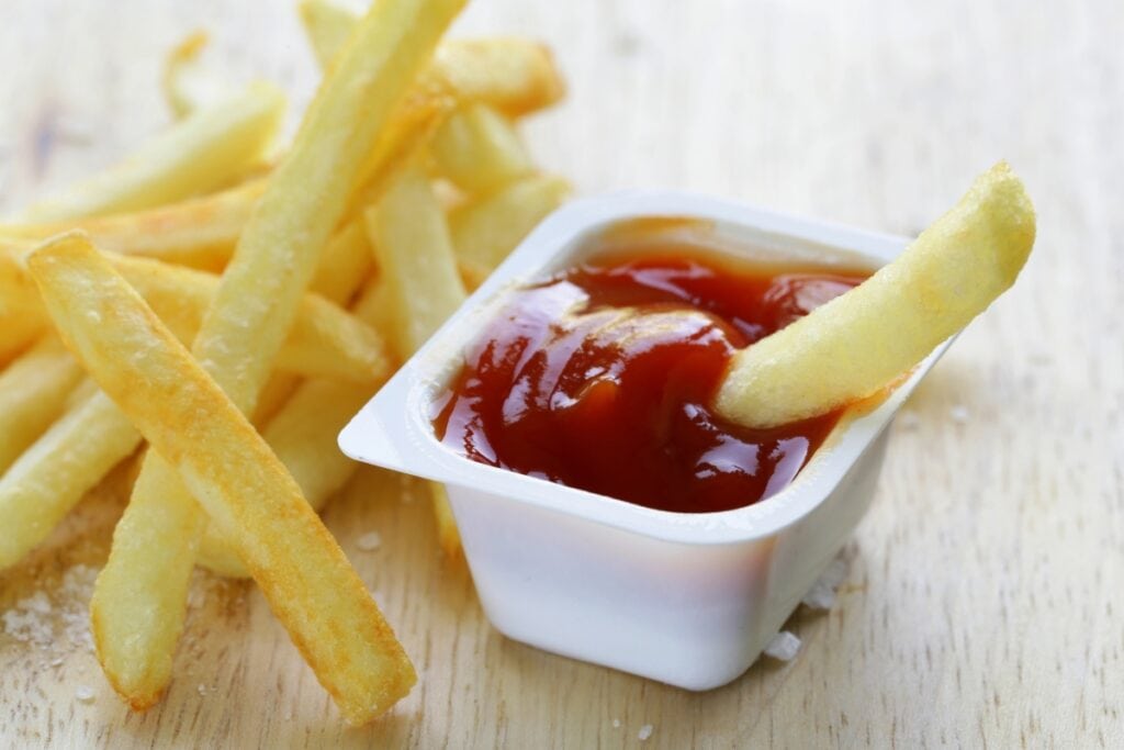 Fries served with a side of ketchup.