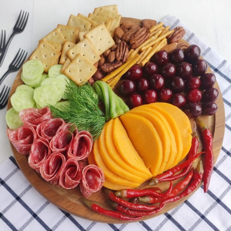 Fall charcuterie board on a checkered cloth.