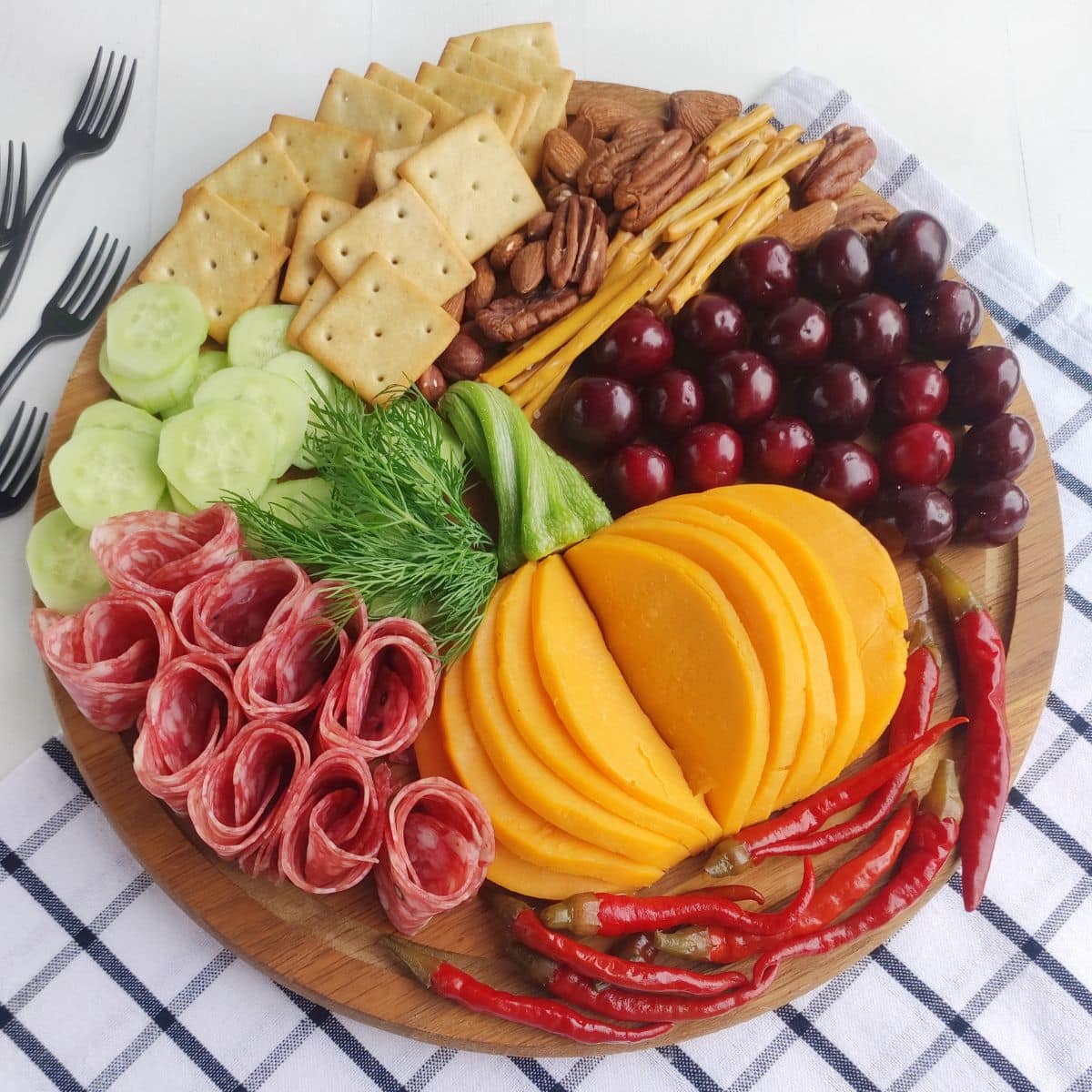 Fall charcuterie board on a checkered cloth.