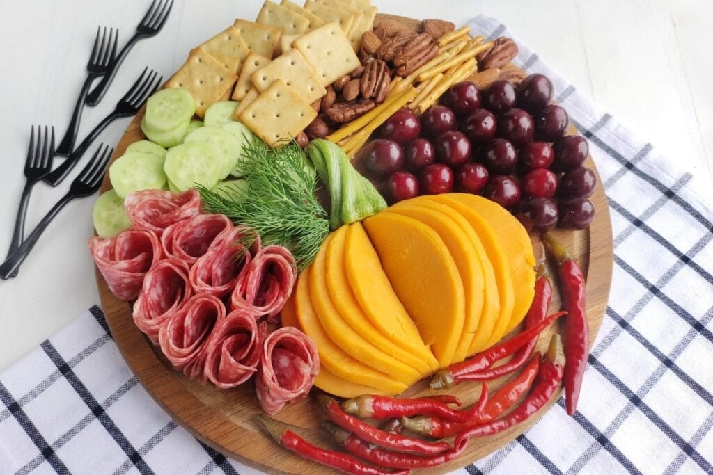 Fall charcuterie board on a checkered cloth.