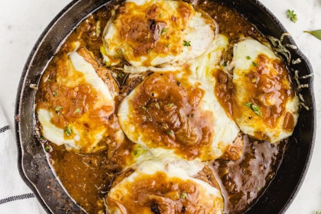 French onion pork chops in a skillet.