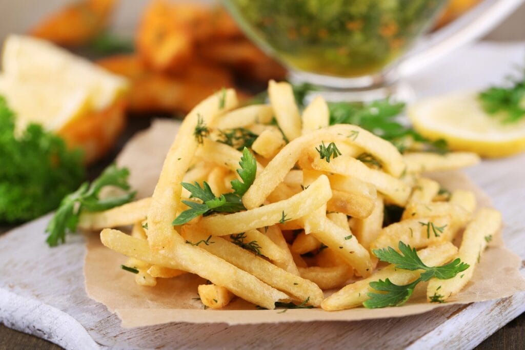Fries on a wooden board.