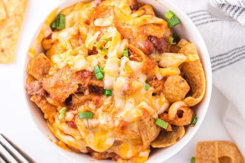 Top view of Frito pie casserole in a white bowl.