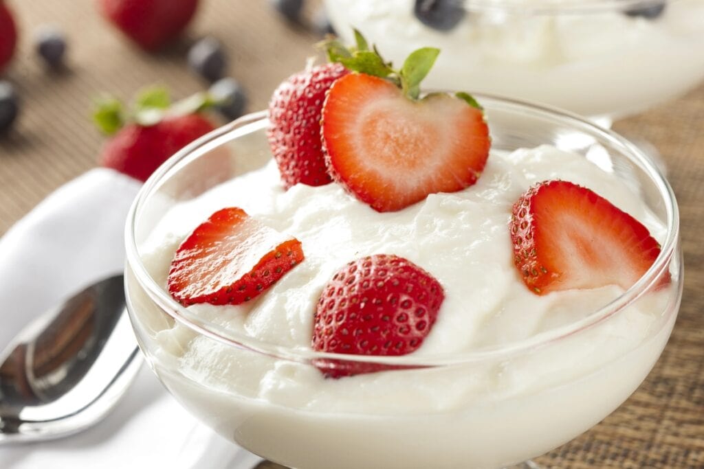 Greek yogurt topped with fresh strawberries.