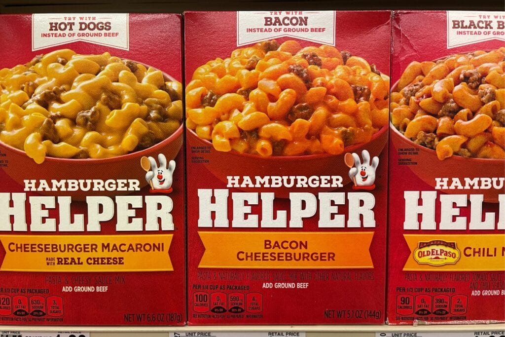 Boxes of Hamburger Helper displayed on a grocery store shelf.