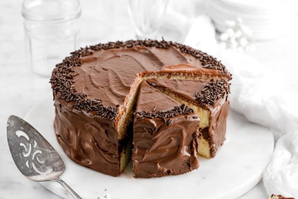 Homemade yellow cake placed on a round marble board.