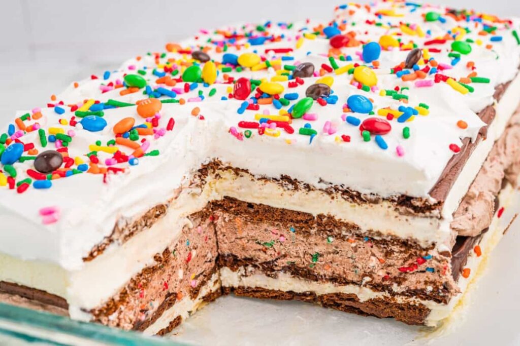 Sliced ice cream sandwich cake with sprinkles and M&M's.