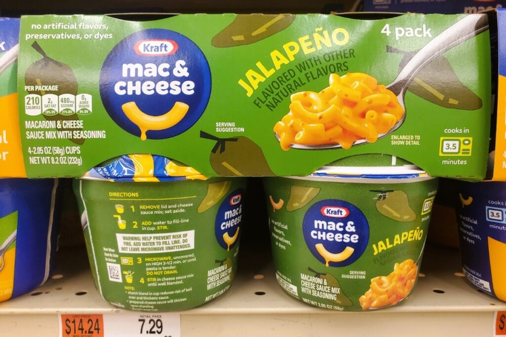 Instant mac and cheese cups displayed on a store shelf.