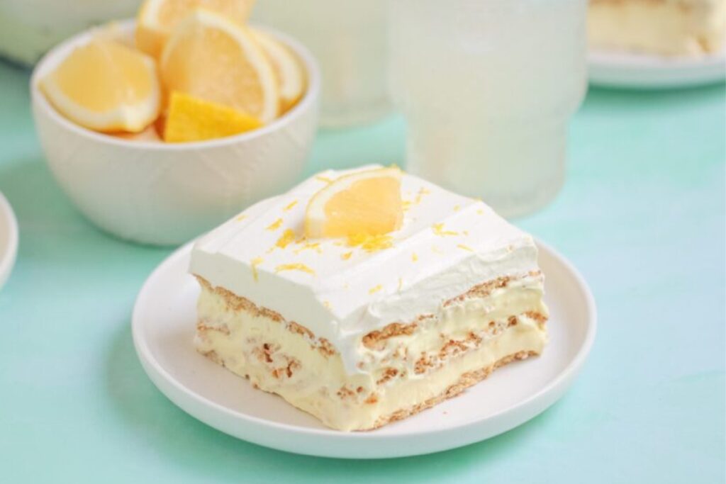 Lemon Ice Box Cake on a white dessert plate.