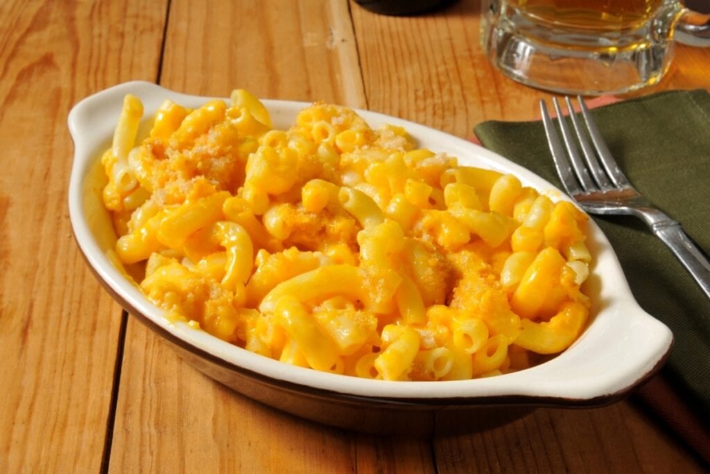 macaroni and cheese served in a white oval bowl.