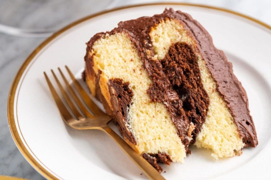 Slice of marble cake on a plate.