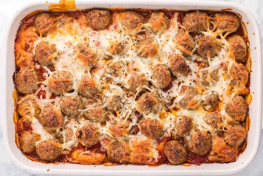 Meatball sub casserole in a white baking dish.