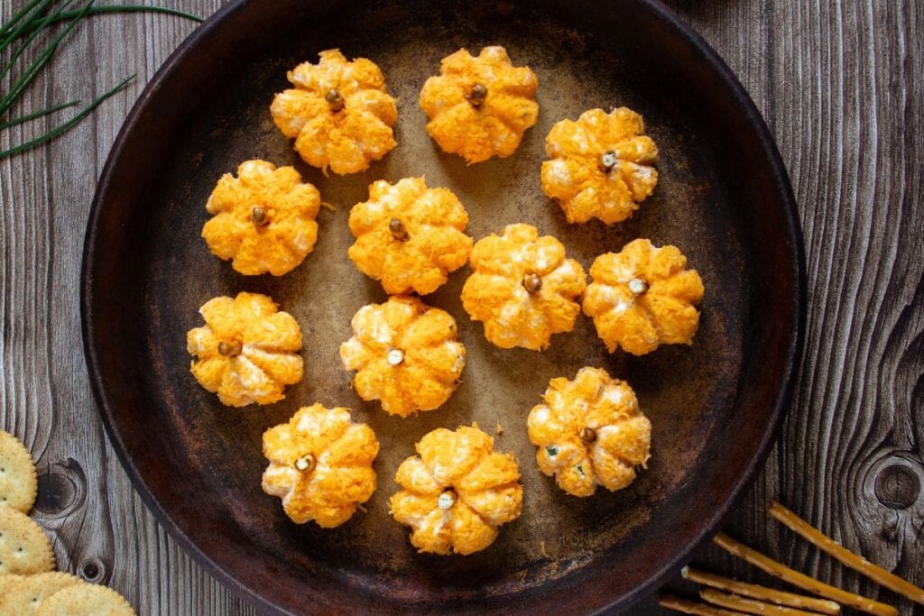 pumpkin cheeseballs on black plate