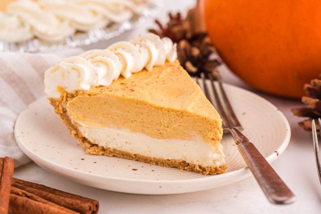 No-bake pumpkin pie cheesecake on a plate with a fork on the side.