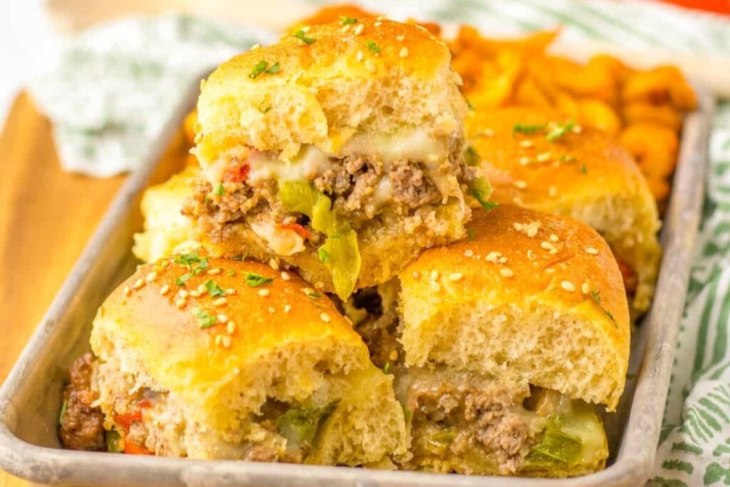 Philly cheesesteak sliders in a rectangular baking dish.