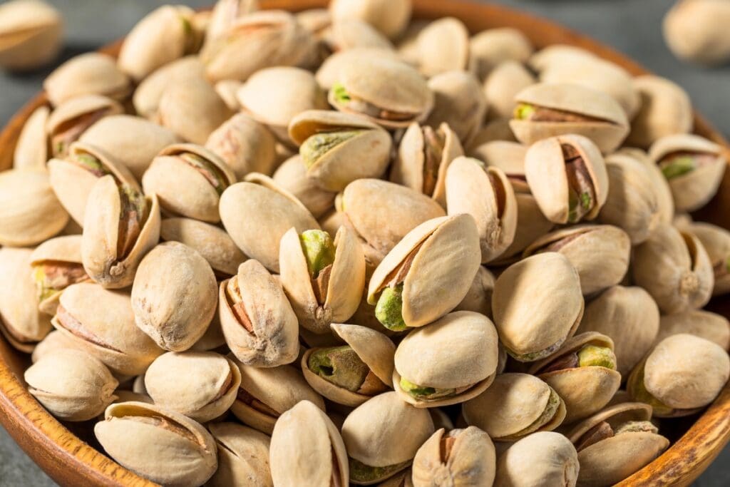 Pistachios in a wooden bowl.