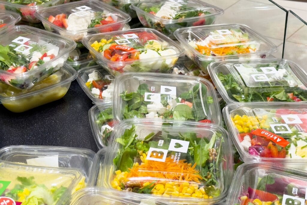 Salad kits in clear containers.