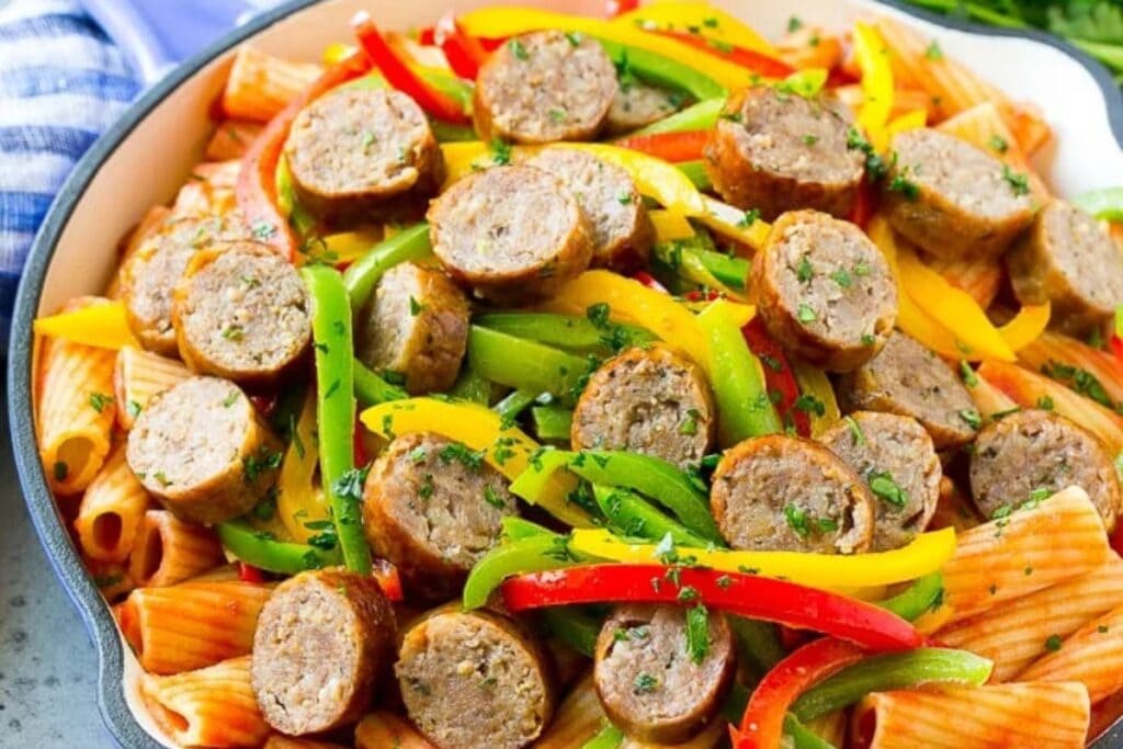 Sausage and pepper pasta on a plate.