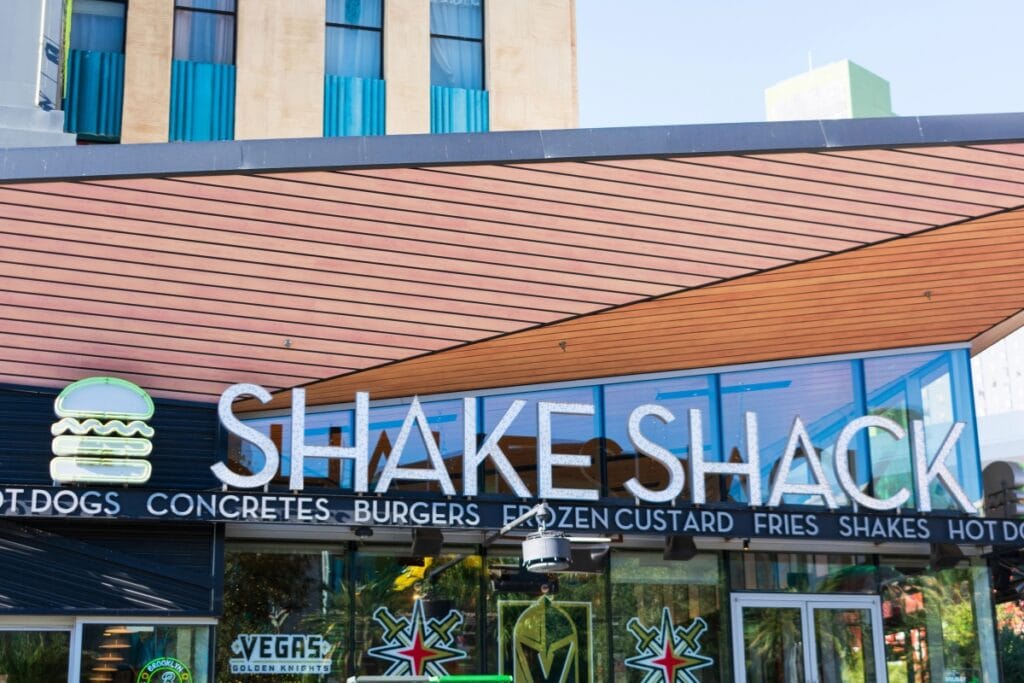hake Shack restaurant exterior showing glass door and logo.