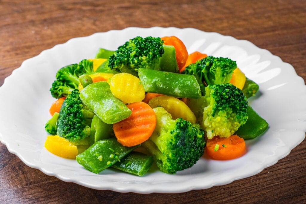 Steamed vegetables on a white plate.