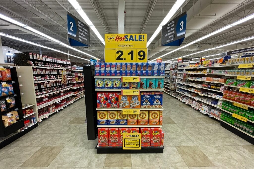 Grocery shelf with a 'Hot Sale' sign displayed above discounted products.