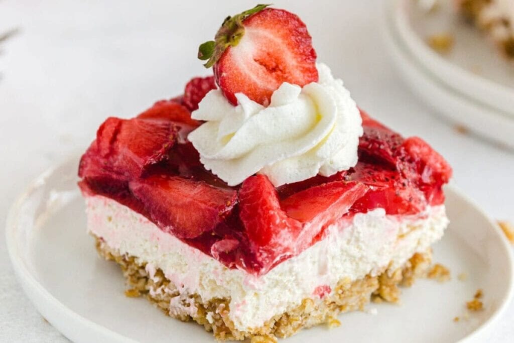 Slice of strawberry pretzel salad on a plate.