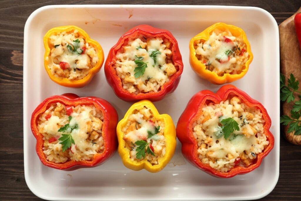 Stuffed peppers on a rectangular white platter.