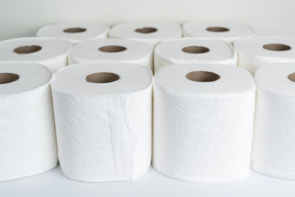 Rolls of toilet paper on a white table.