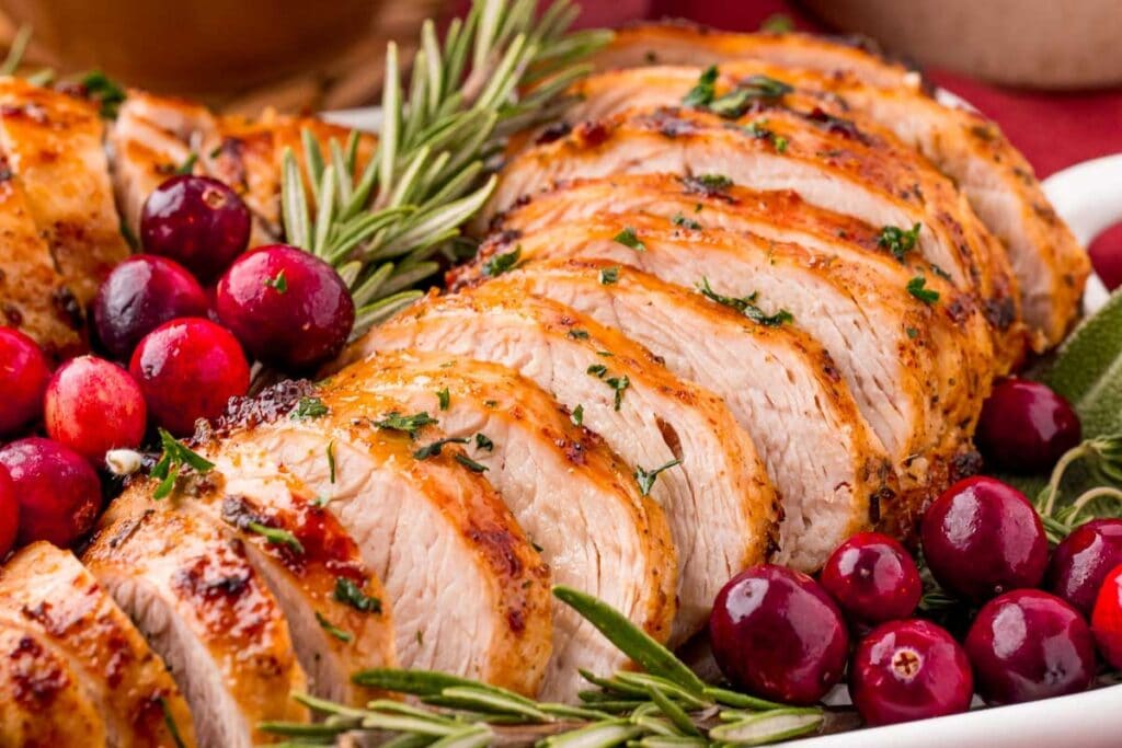 Sliced turkey tenderloin served on a platter.