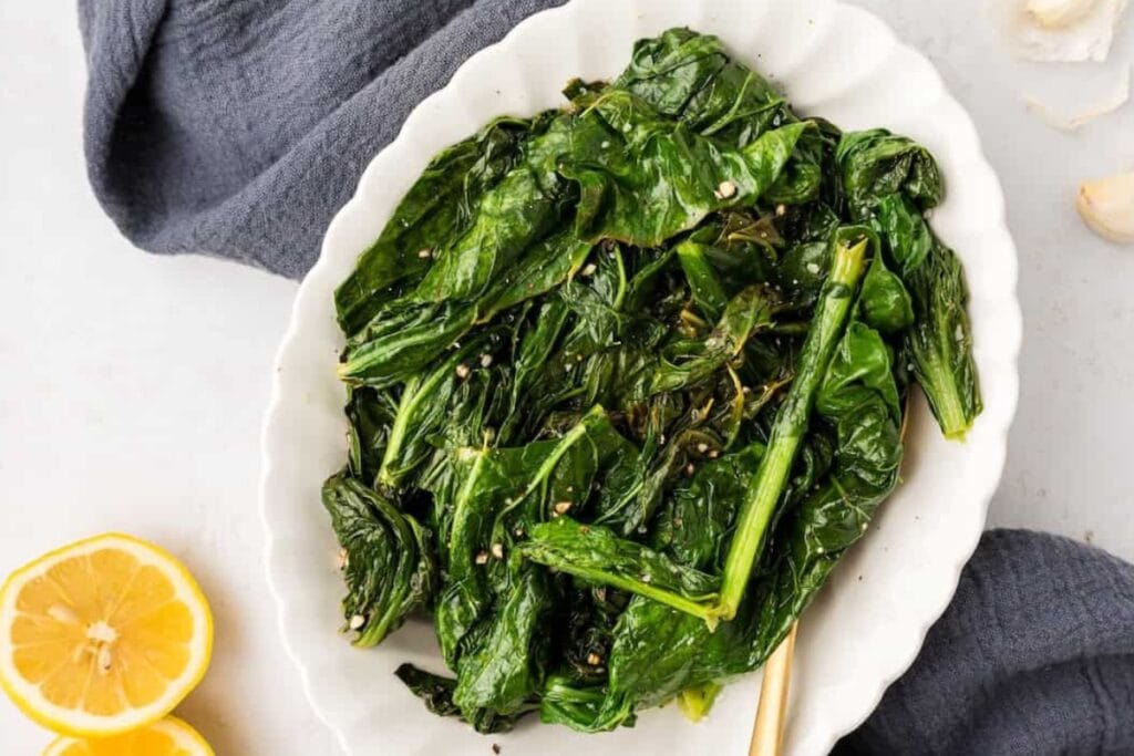 Turnip greens in a white oval plate.