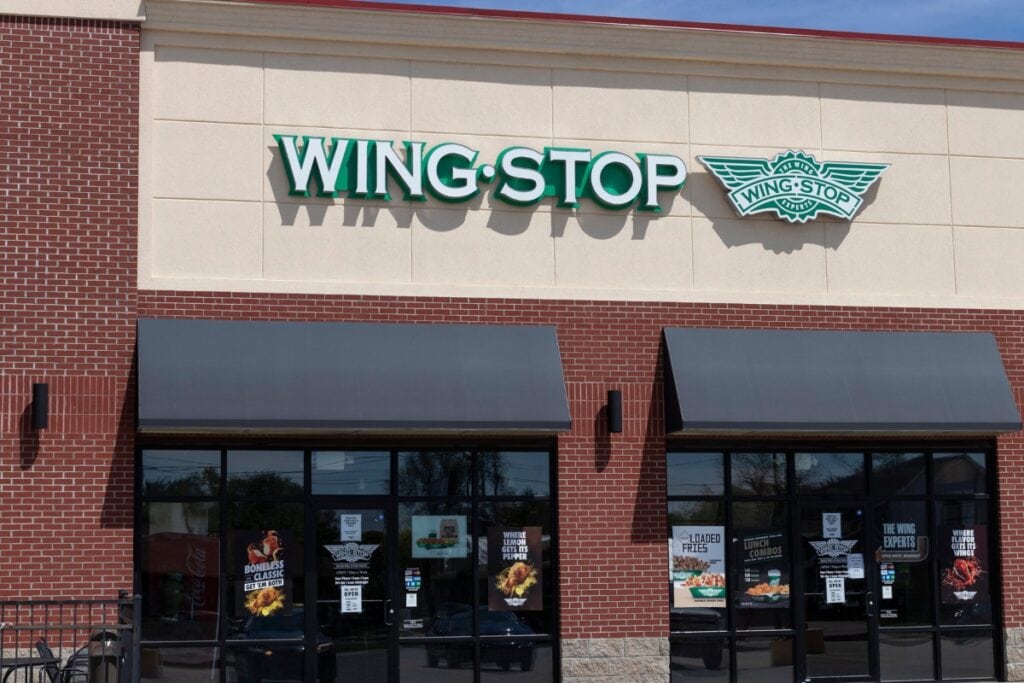 Wingstop restaurant exterior with glass walls and visible logo.