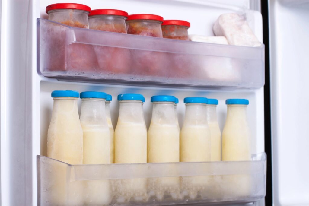Bottled milk stored in a freezer.
