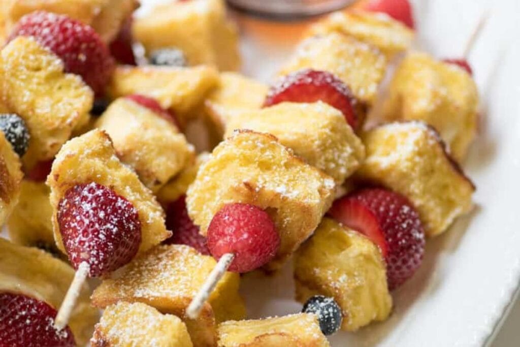 A close up shot of berry french toast kabobs.