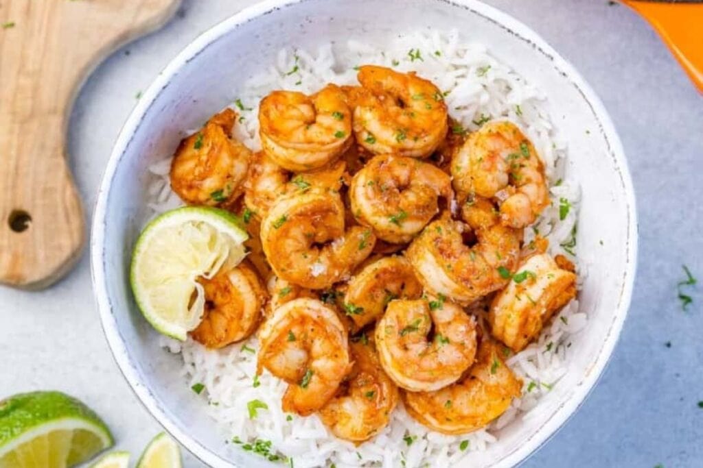 A bowl of cajun shrimp and rice.