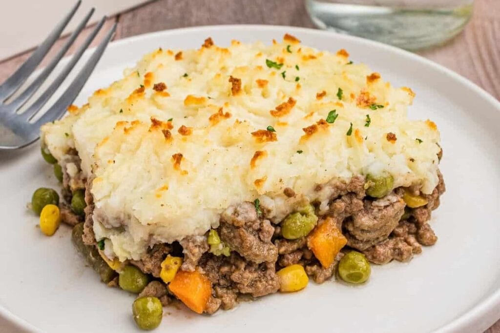 A slice of cottage pie on a plate.