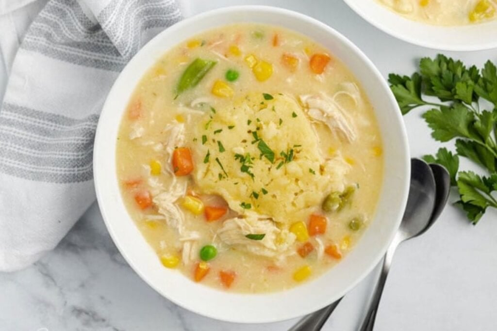 A bowl of chicken and dumplings.