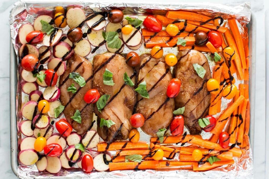 A close up shot of one pan chicken and veggies.