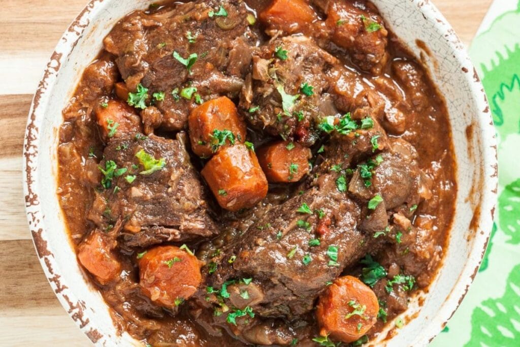 A close up shot of pot roast with gravy.