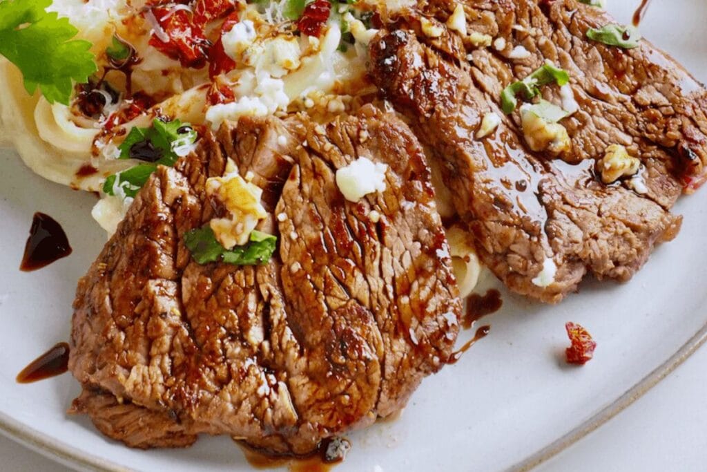 A close up shot of steak alfredo.