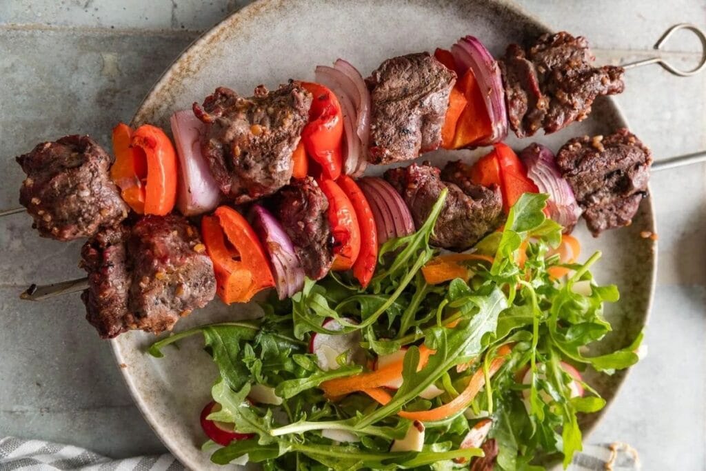 A close up shot of steak kabobs.
