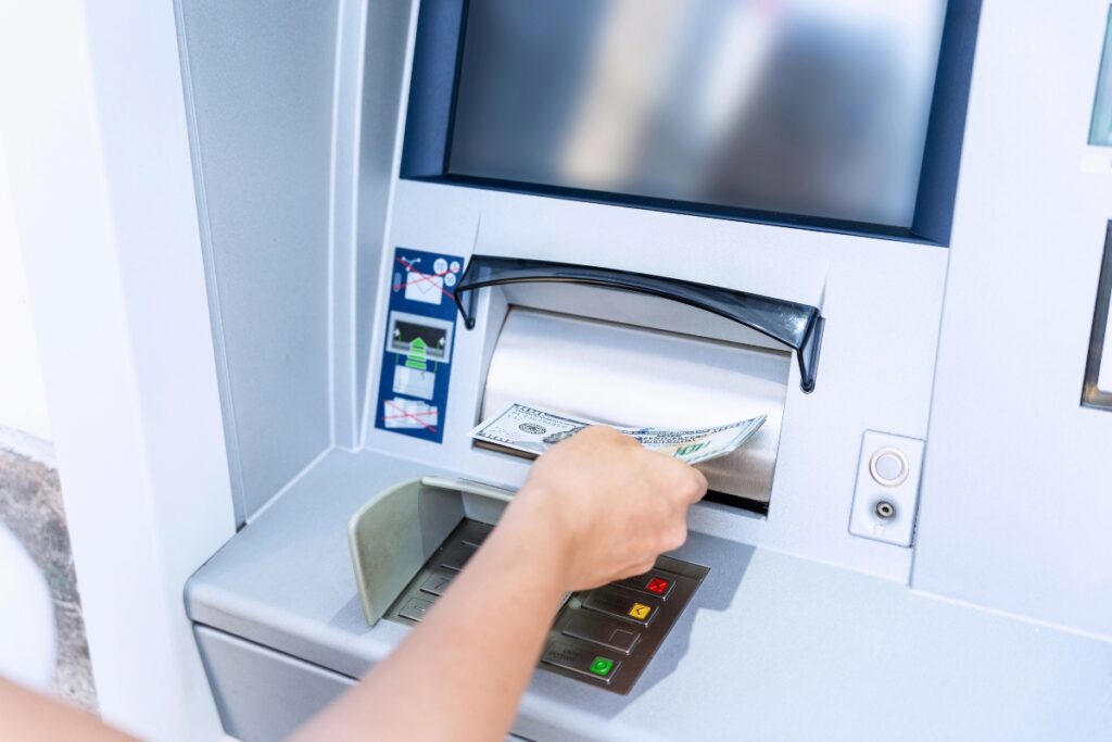 Woman withdrawing cash from an ATM.