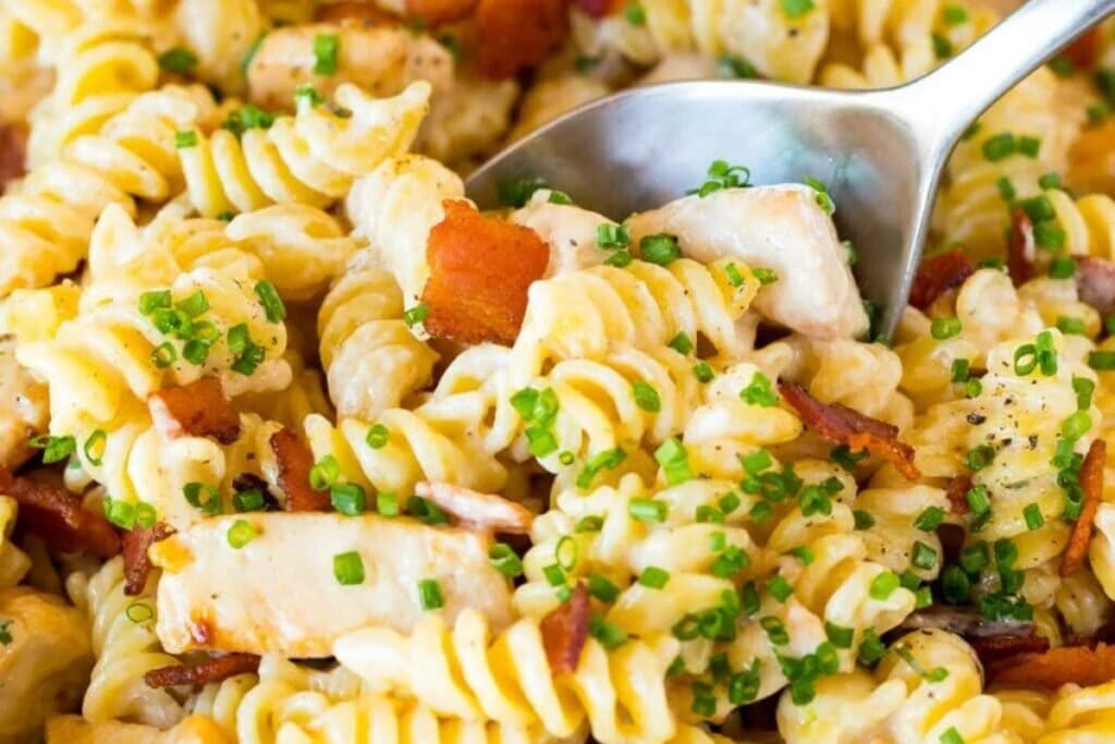 Close-up of bacon ranch chicken pasta with rotini noodles.