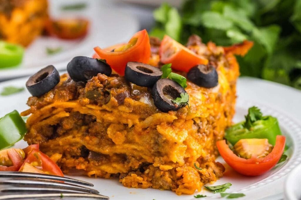 Slice of beef enchilada casserole on a plate.